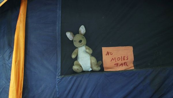 A note on a tent in the migrant caravan traversing Central and North America reads 'Do not disturb.'