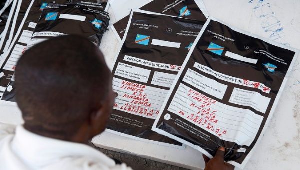 A man reviews voting materials at a tallying center in Kinshasa, Congo, Jan. 3, 2019.