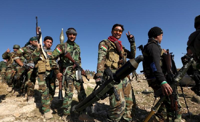 Members of the Kurdish peshmerga forces gather in the town of Sinjar, Iraq November 13, 2015.