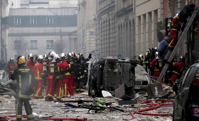 Firemen and police officers work at the site of an explosion in a bakery shop in Paris on Jan. 12.