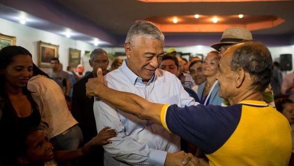 Claudio Fermin, campaign manager for the Venezuela opposition shaking hands with voters during the campaign