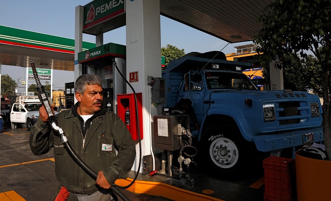 An employee is seen after filling a truck with fuel diesel at a gas station, in Mexico City, Mexico January 15, 2019.