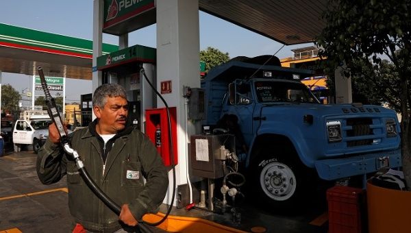 An employee is seen after filling a truck with fuel diesel at a gas station, in Mexico City, Mexico January 15, 2019.