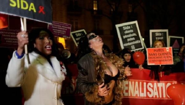 Sex workers attend a protest demonstration after French deputies voted for a reform of prostitution law in Paris