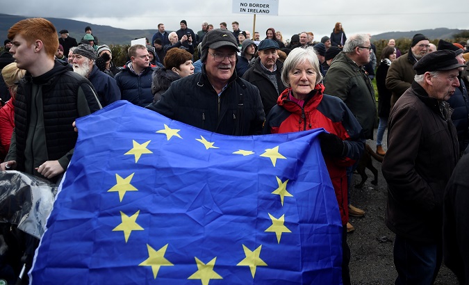 People hold a European Union flag during a protest by anti-Brexit campaigners, Borders Against Brexit in Carrickcarnan, Ireland, Jan. 26, 2019.