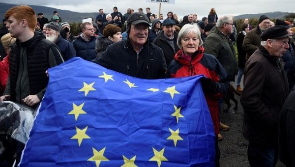 People hold a European Union flag during a protest by anti-Brexit campaigners, Borders Against Brexit in Carrickcarnan, Ireland, Jan. 26, 2019. 