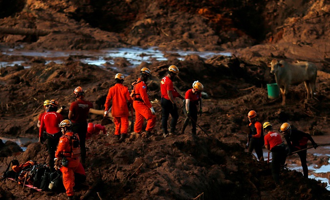Members of a rescue team search for victims after a tailings dam owned by Brazilian mining company Vale SA collapsed, in Brumadinho, Brazil Jan. 28, 2019.