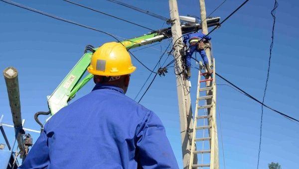 Workers from the Cuban electricity company working to repair a post damaged by the violent tornado in Havana. Jan. 30, 2019.