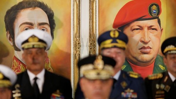 Portraits of Simon Bolivar and Venezuela's late President Hugo Chavez are seen during a news conference, Venezuela Jan. 24, 2019.