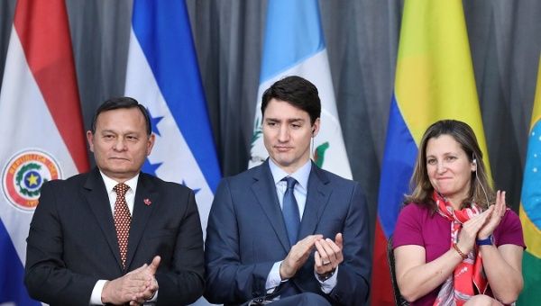 Peru's Foreign Minister Popolizio, Canada's PM Trudeau and Canada's Foreign Minister Freeland applaud during the opening session of the Lima Group meeting in Ottawa