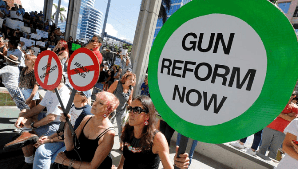  Protesters hold signs as they call for a reform of gun laws three days after the shooting at Marjory Stoneman Douglas High School, at a rally in Fort Lauderdale, Florida, U.S., Feb. 17, 2018. 
