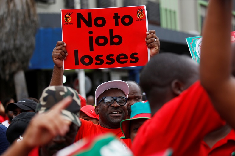 A member of the Confederation of South African Trade Unions (COSATU) holds a placard during a march against job losses in Durban, South Africa, February 13, 2019. 