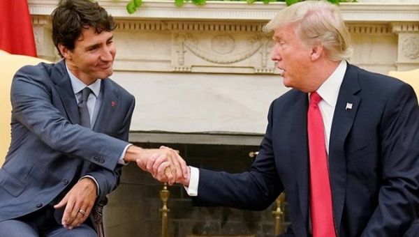 Canada's Prime Minister Justin Trudeau shakes hands with US President Donald Trump as they meet about the NAFTA trade agreement at the White House Oct. 2017.