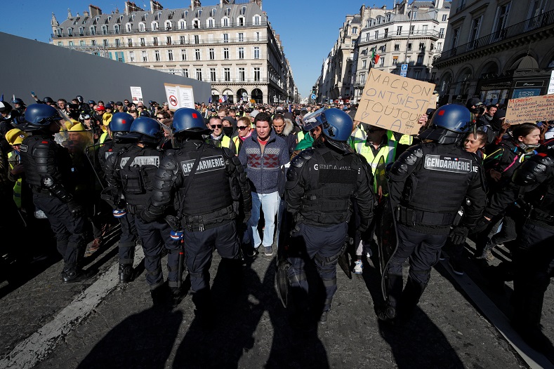 French police cannot stop Yellow Vest protesters as they move through the streets of Paris, France, on Feb. 23, 2019.