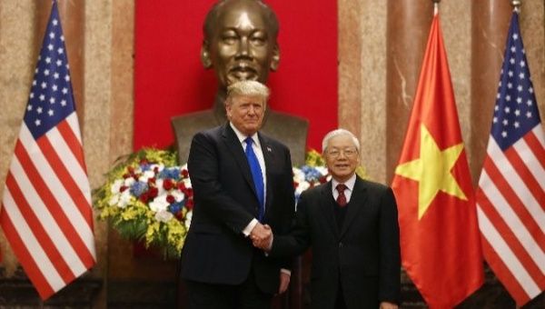 Trump holds bilateral talks with Vietnamese President Nguyen Phu Trong (R) ahead of summit. 