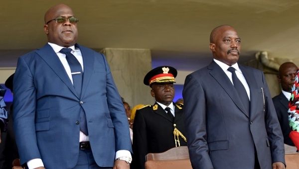 Democratic Republic of Congo's outgoing President Joseph Kabila (right) and his successor Felix Tshisekedi stand during the latter's inauguration ceremony.