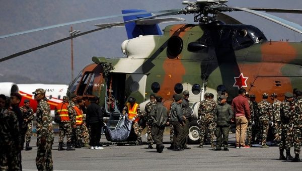 Nepalese Army members carry the body of one of the victims of the helicopter crash, in Kathmandu, Nepal.