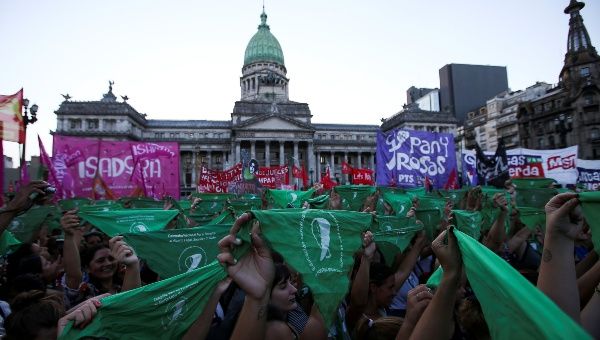 Abortion rights activists hold up green handkerchiefs, symbolize the abortion rights movement, outside the National Congress in Buenos Aires, Argentina, February 19, 2019