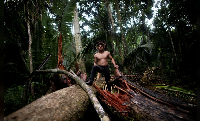 An Indigenous man named Tebu of Uru-eu-wau-wau tribe, looks upon an area deforested by invaders of the Alto Jaru village, near Campo Novo de Rondonia, Brazil Feb. 1, 2019.