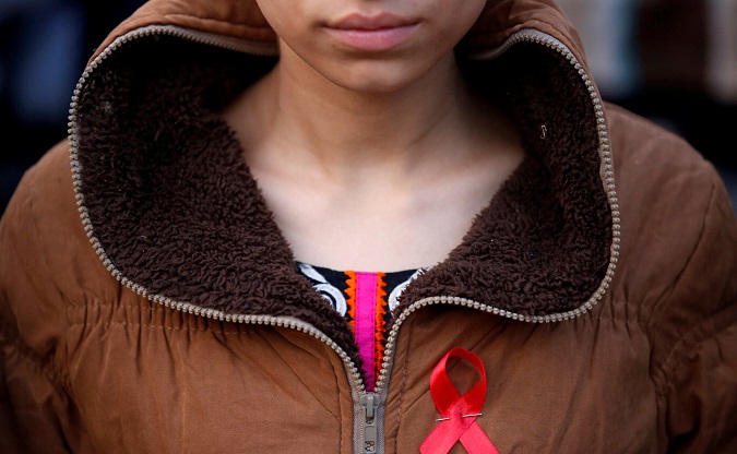 A participant with a red ribbon pin takes part in a HIV/AIDS awareness campaign ahead of World Aids Day, in Kathmandu, Nepal November 30, 2016.