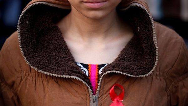  A participant with a red ribbon pin takes part in a HIV/AIDS awareness campaign ahead of World Aids Day, in Kathmandu, Nepal November 30, 2016.