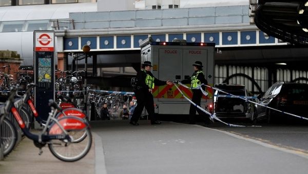 Police officers secure the scene where a suspicious package was retrieved at Waterloo railway station in London. 
