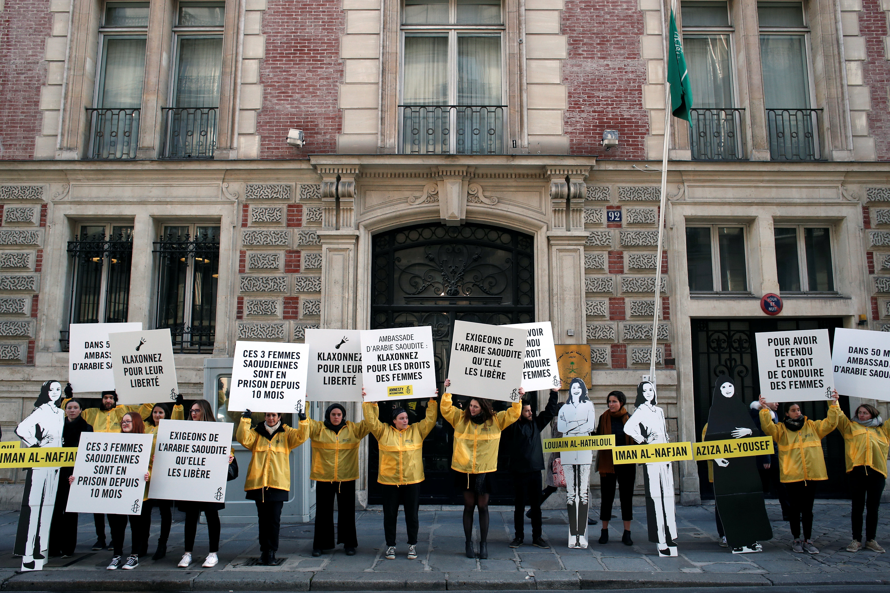 Demonstrators from Amnesty International hold placards outside the Saudi Arabian Embassy on International Women's day in Paris, France, March 8, 2019