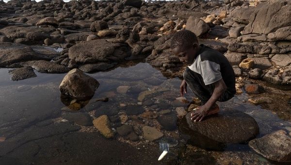 A Senegalese child plays with plastic waste at the coast of Ngor in Dakar, Senegal, Mar. 12, 2019.