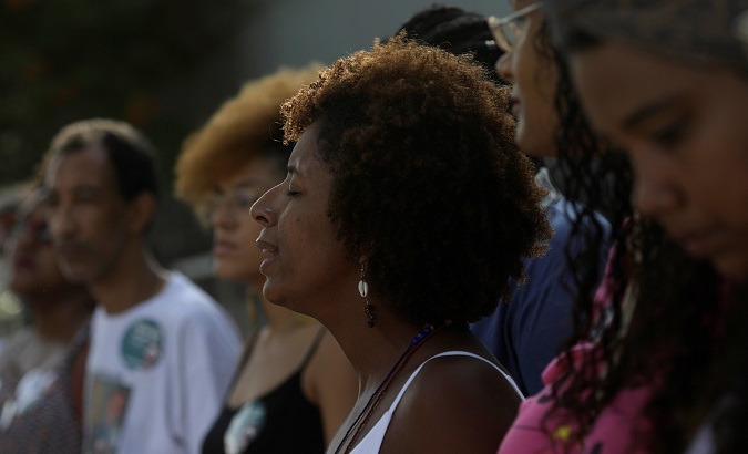Women participate in a demonstration to commemorate the death anniversary of Afro-Brazilian lesbian activist and councilwoman Marielle Franco.