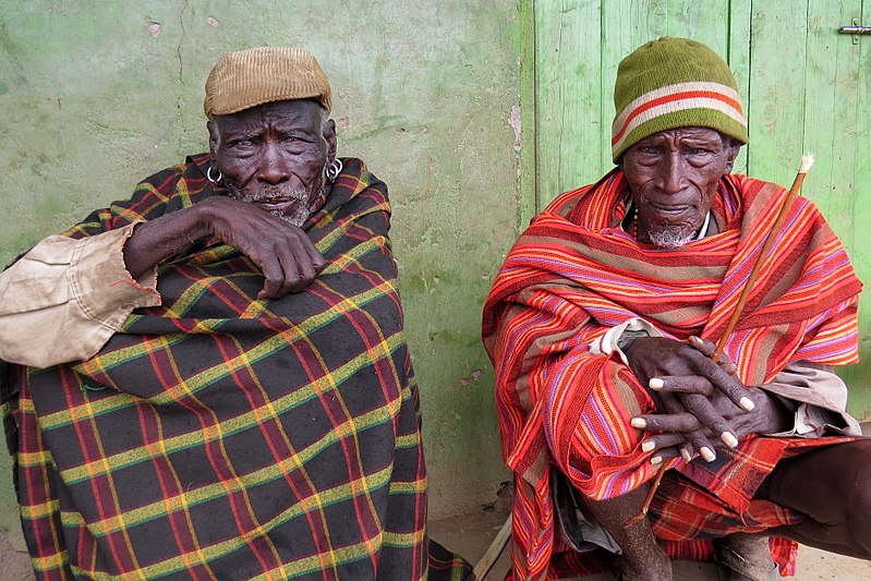 Two herders of the Turkana tribe take shelter from a rainstorm in Kenya's northern arid lands in 2015.