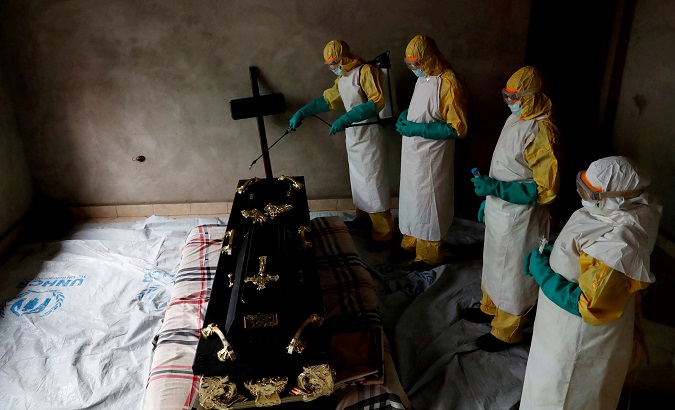 A healthcare worker sprays a room during an Ebola pacient's funeral in Beni, DR Congo, Dec. 9, 2018.