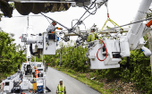Prime Power transmission and distribution specialists repair power lines in Rio Grande, Puerto Rico.