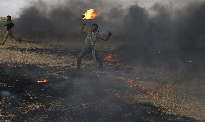 A Palestinian during clashes with Israeli troops at Israel-Gaza border, in the southern Gaza Strip April 3, 2018