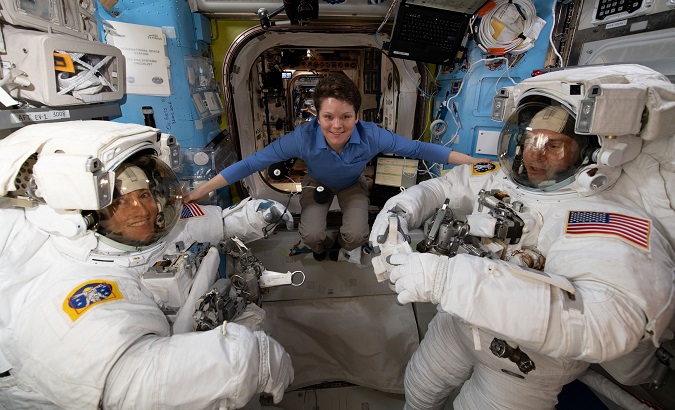 NASA astronaut Anne McClain assists fellow NASA astronauts Christina Koch (L) and Nick Hague as they verify their U.S. spacesuits are sized correctly and fit properly.