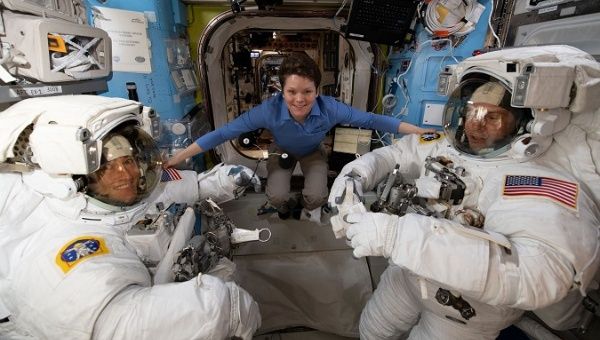 NASA astronaut Anne McClain assists fellow NASA astronauts Christina Koch (L) and Nick Hague as they verify their U.S. spacesuits are sized correctly and fit properly.