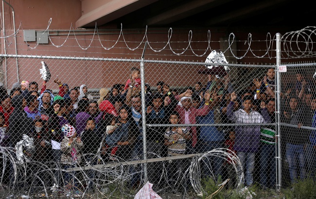 Central American migrants are seen inside an enclosure where they are being held by U.S. Customs and Border Protection (CBP), in El Paso, Texas, U.S. March 27, 2019.