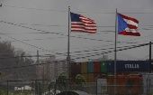 Puerto Rico and United States flags flying against hurricane winds. 