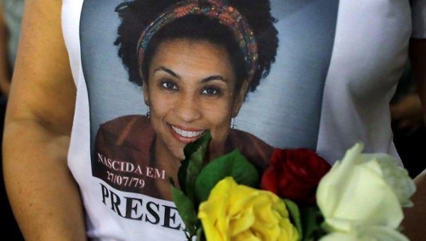 A woman attends a mass marking the first anniversary of Marielle Franco's murder, in Rio de Janeiro, Brazil March 14, 2019.