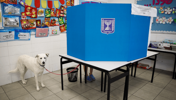Dog stands by as owner votes in Israeli Knesset elections. April 9, 2019