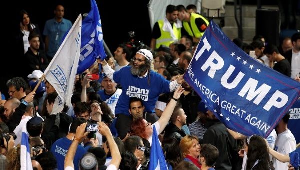 Supporter of Israeli Prime Minister Benjamin Netanyahu's Likud party waves flags