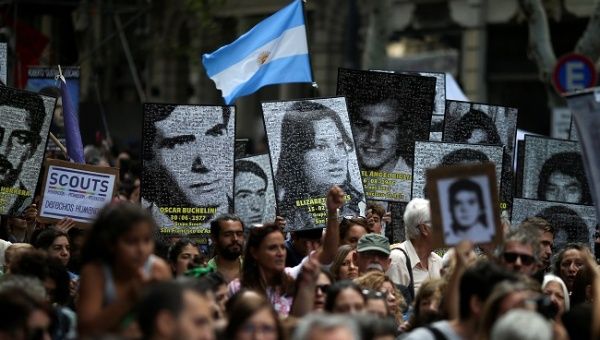 Demonstrators hold images of people who disappeared, during the march towards Plaza de Mayo square to commemorate the 43rd anniversary of the 1976 military coup, in Buenos Aires, Argentina March 24, 2019. 