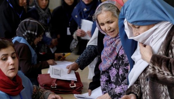 Afghan women line up at a polling station during parliamentary elections in Kabul