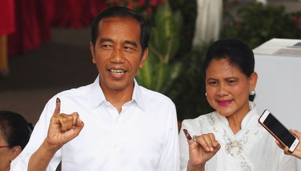 Indonesian President Joko Widodo and first lady Iriana Joko Widodo show their ink-stained fingers after casting their ballots.