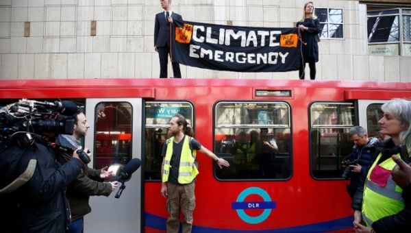 A climate change activist demonstrates during the Extinction Rebellion protest at Canary Wharf DLR station in London, Britain April 17, 2019.