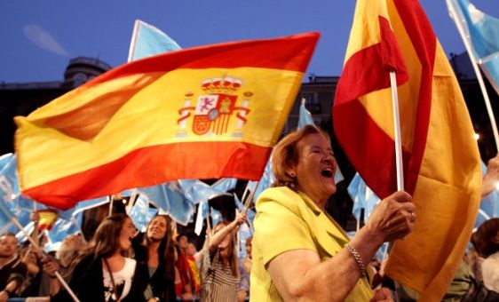 Demonstrators holding the Spanish flag.