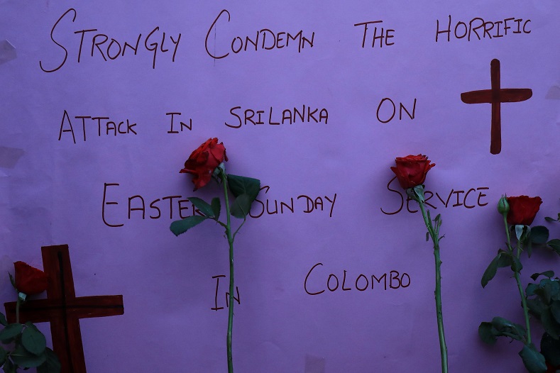 A sign and roses placed for the victims of Sri Lanka's serial bomb blasts, are displayed outside a church in Peshawar, Pakistan April 21, 2019.