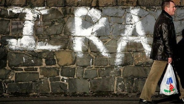 A man walks past Irish Republican graffiti in west Belfast in a file photo.