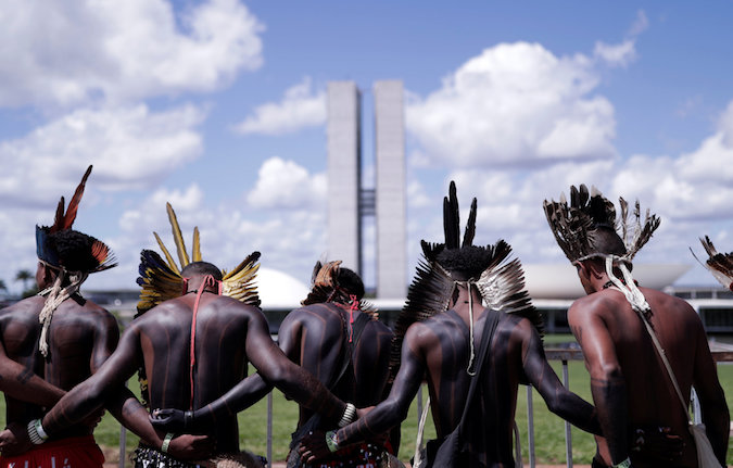 Indigenous men in front of National Congress during a protest in Brasilia, Brazil, April 25, 2019.