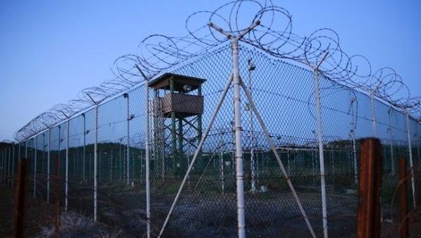 Chain link fence and concertina wire surrounds a deserted guard tower within Joint Task Force Guantanamo's Camp Delta at the U.S. Naval Base in Guantanamo Bay, Cuba March 21, 2016.