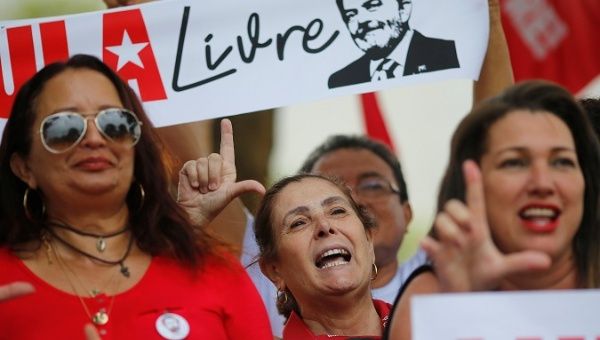 Supporters of Brazil's former President Luiz Inacio Lula da Silva react outside the Superior Court in Brasilia, Brazil April 23, 2019.